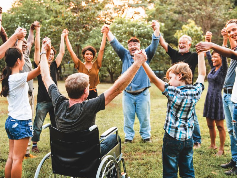 Group of people holding hand together in the park