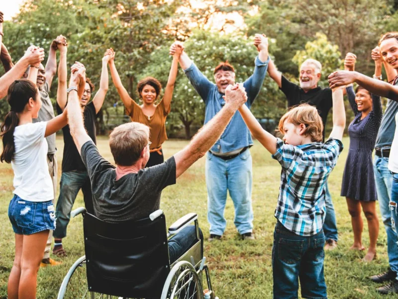 Group of people holding hand together in the park